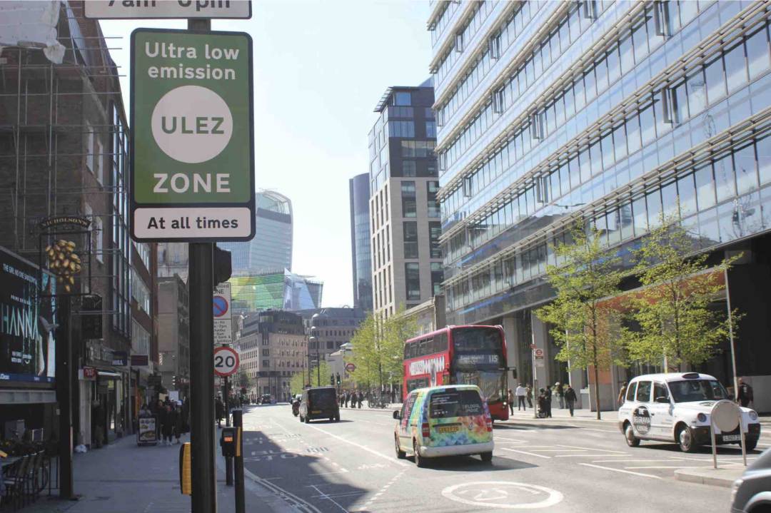 London City Centre Road With Vehicles And A ULEZ Sign